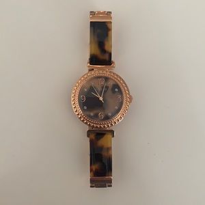 GUESS a women’s watch- Rose gold and tortoise shell